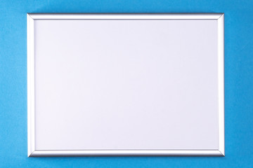 Silver frame with a white insert on a light blue background.