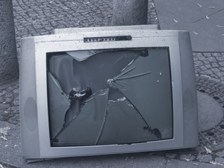Old television with a broken screen
