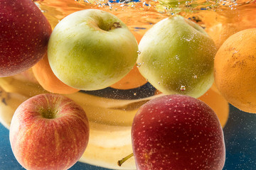 lot of fresh fruit splashing in fresh water