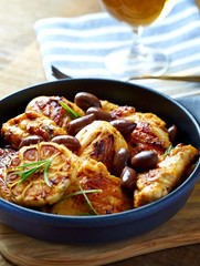 Grilled chicken pieces with kalamata olives and fresh rosemary. Close up.
