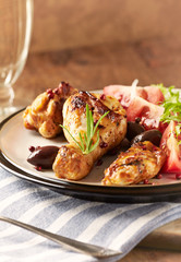 Grilled chicken pieces with fresh salad. Wooden background.