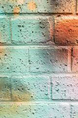 Background: Colorful brick wall due to graffiti