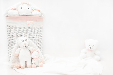 White linen basket.  Children wicker laundry basket with stuffed toys.