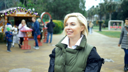 Fototapeta na wymiar beautiful stylish trendy blond woman walking in a city Park in autumn