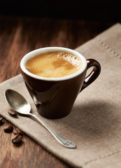 Cup of coffee on rustic wooden background