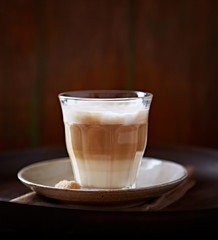 Caffe latte on brown background. Front view. 