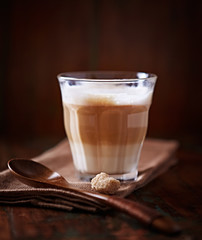 Caffe latte on brown background. Front view.