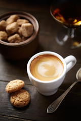 Cup of coffee on rustic wooden background	