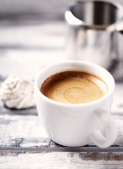 Cup of coffee on bright wooden background. Close up.	