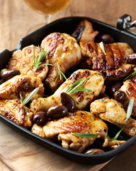 Grilled chicken pieces with kalamata olives and fresh rosemary.
