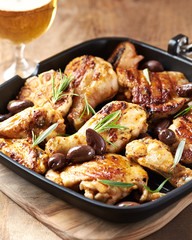 Grilled chicken pieces with kalamata olives and fresh rosemary.