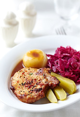 Fried Pork Steak with potato dumplings. Bright background.
