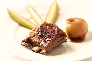 Fried pork ribs with potato dumplings. Bright background.