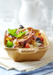 Penne pasta with fried pork tenderloin, cherry tomatoes and black olives. Oven baked.