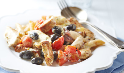  Penne pasta with fried pork tenderloin, cherry tomatoes and black olives. Oven baked.