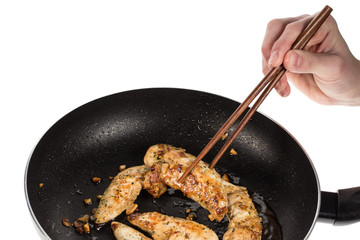hand with chopsticks with meat  isolated on white background