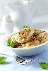 Dumplings with potato and cottage cheese stuffing (pierogi). Traditional Polish Christmas Dinner. Bright background. 