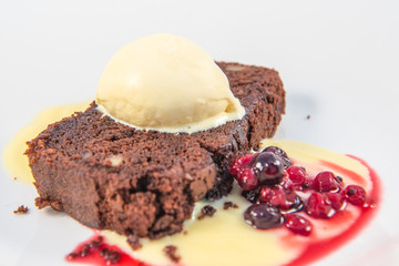 A chocolate and walnut brownie with vanilla icecream and berries