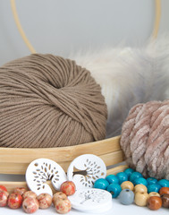 Fototapeta na wymiar Balls of yarn, wool, rope and beads of earth blue and white colors.