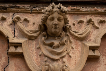 Beautiful window in old house. Mascaron woman head