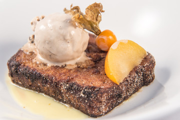 A spanish style French toast with vanilla ice cream