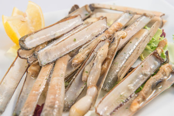 A dish of grilled razor clams