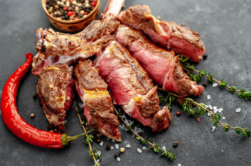 steak - sliced ​​grilled beef tomahawk with spices on a stone background. with copy space for your text