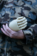 soldier with prosthetic hand wearing a military shirt