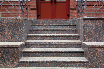 granite staircase with a rise to the front door, threshold with steps entrance close up front view.