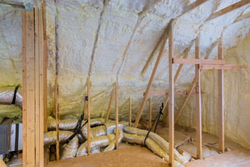 Installation new house of HVAC tubing vents heating system on the roof of under construction with wooden beams