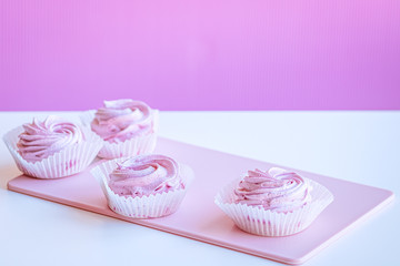 Soft pink marshmallows on the table. Copy space.