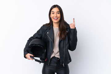 Young brunette woman with a motorcycle helmet over isolated white background pointing up a great idea