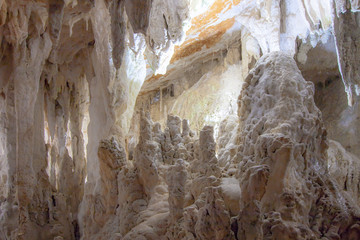 White cave with heavy slope and several thin colonms.  Yarrangobilly Caves, Kosciuszko National Park, NSW, Australia.