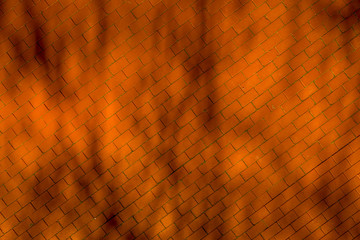 Red orange brick sidewalk pattern from the air with shadows of branches