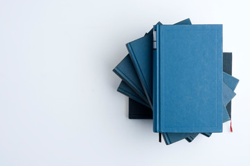Classic blue book stack on the right side. top view, white background, top view