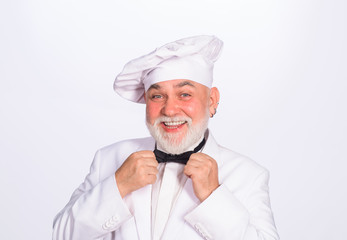 Cooking and food concept. Chief cook and professional culinary. Male chef. Food concept. Bearded chef in uniform, hat and bow tie. Professional chef, cook or baker. Chef man in uniform adjust bow tie.