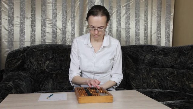 Vintage abacus (made in USSR). Woman accountant  counts with abacus