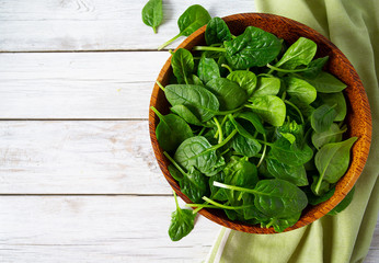 fresh spinach on white wooden surface