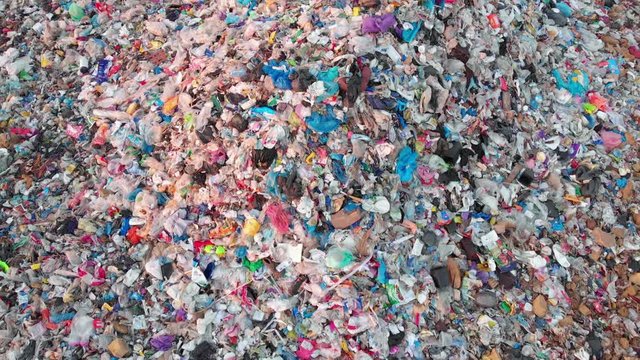 Aerial top down view through Trash on landfill site, pollution environmental problem