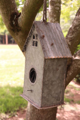 metal birdhouse on tree