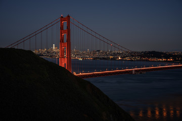 Fototapeta na wymiar Lights of the Golden Gate Reflect in the Water Below