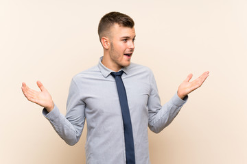 Young blonde businessman over isolated background with surprise facial expression