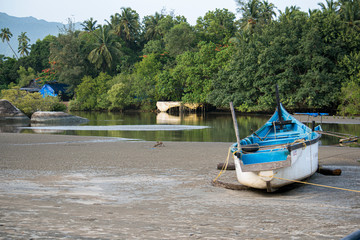 Fototapeta na wymiar Fishing boat near backwater in Goa, India