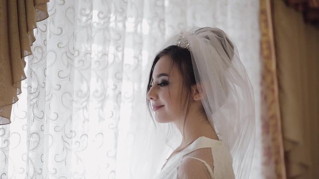 Beautiful and lovely bride in night gown and veil. Wedding morning. Slow motion