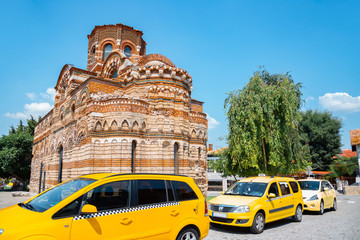 Church of Christ Pantocrator with yellow taxi car in Nessebar, Bulgaria