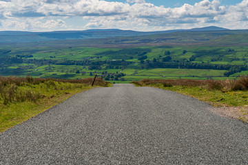 Fototapeta na wymiar Rural road in the Yorkshire Dales near Askrigg, North Yorkshire, England, UK