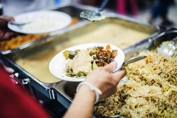 The hands of the poor have been begging to donate food from the donor, the concept of feeding, helping, sharing.