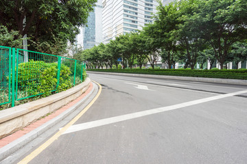 empty road with zebra crossing and skyscrapers in modern city