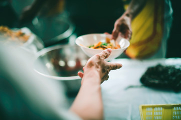 The concept of donating food to the poor in the community, providing free food to the homeless.