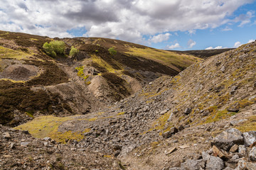 The remains of Bunton Mine with the Gunnerside Gill landscape, near Gunnerside, North Yorkshire, England, UK